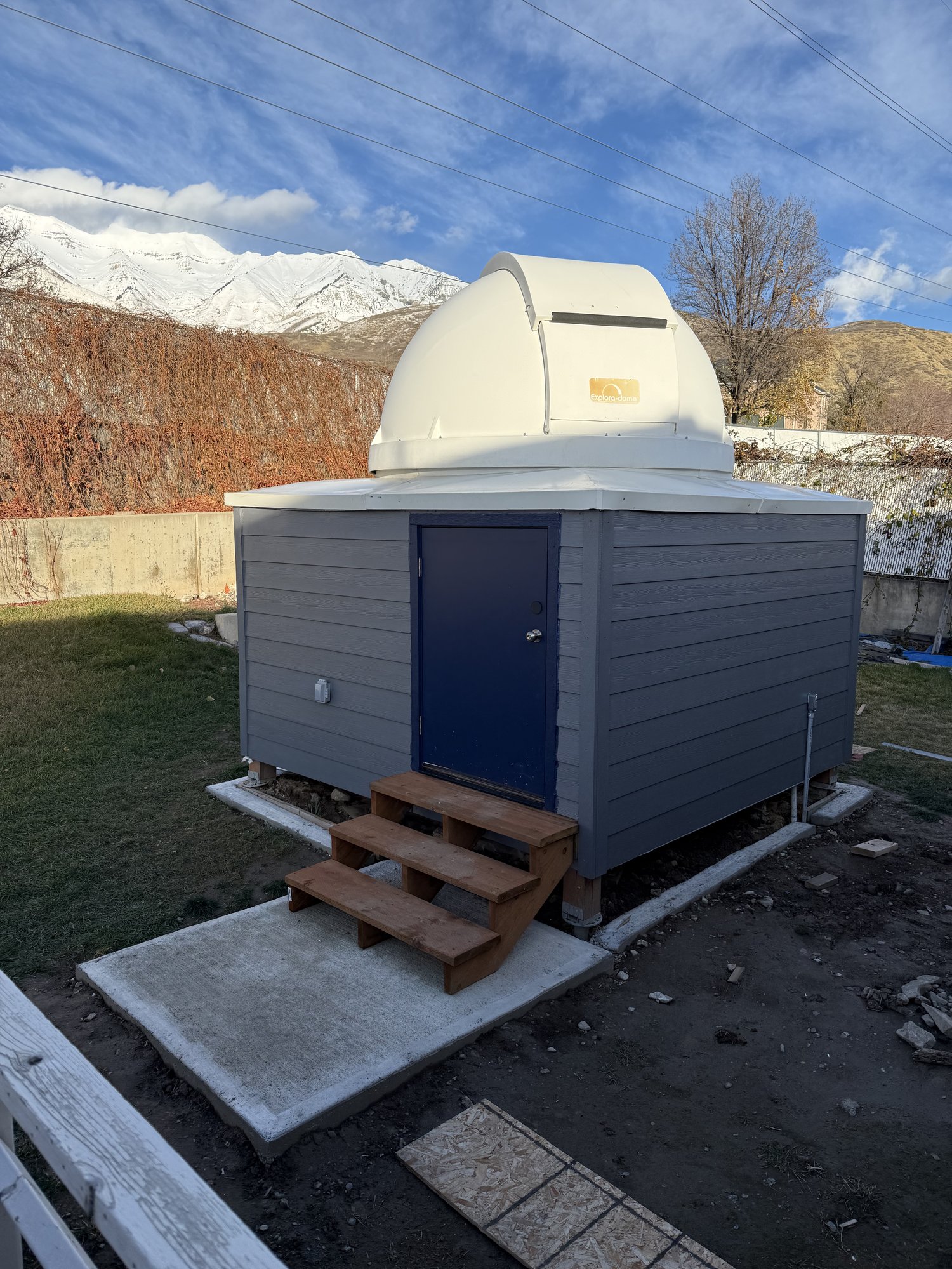 The finished observatory, dome closed, with the Wasatch mountains in the background